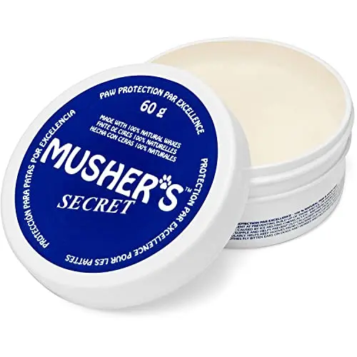 Musher's Secret dog paw wax in a white tin with all-natural labeling