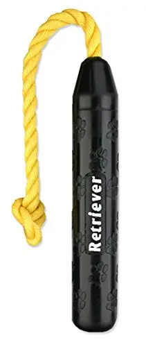 A black, tire-shaped rubber dog toy with a rope handle, floating in water.