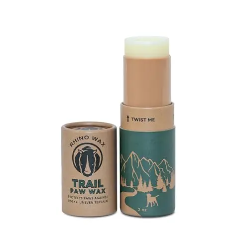 Rhino Wax Dog Paw Trail Wax tube applying balm to a dog's paw pad