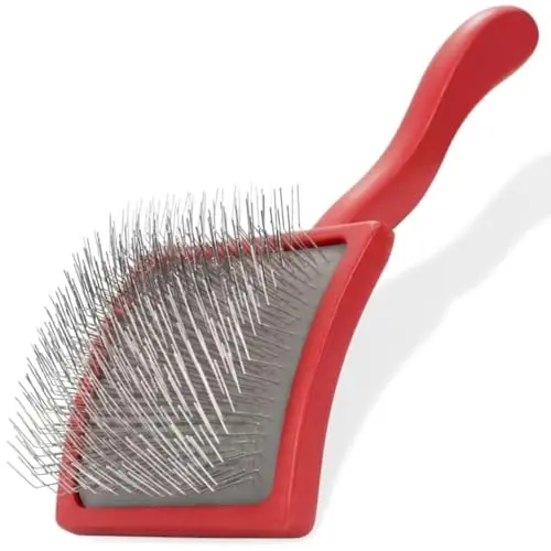 Mbala curved slicker brush in coral with high-density pins and non-slip grip